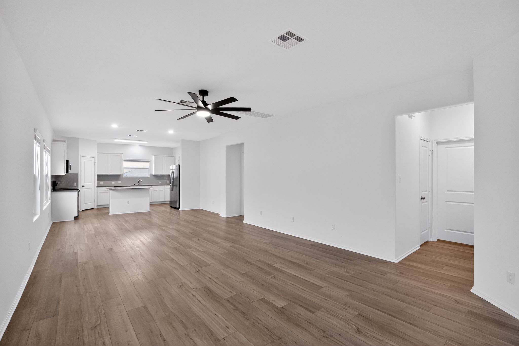 412 Perfect World Loop Jarrell, TX 76537 - Photo 2 of 15 Open-concept living area with wood-finish flooring, a modern ceiling fan, and recessed lighting