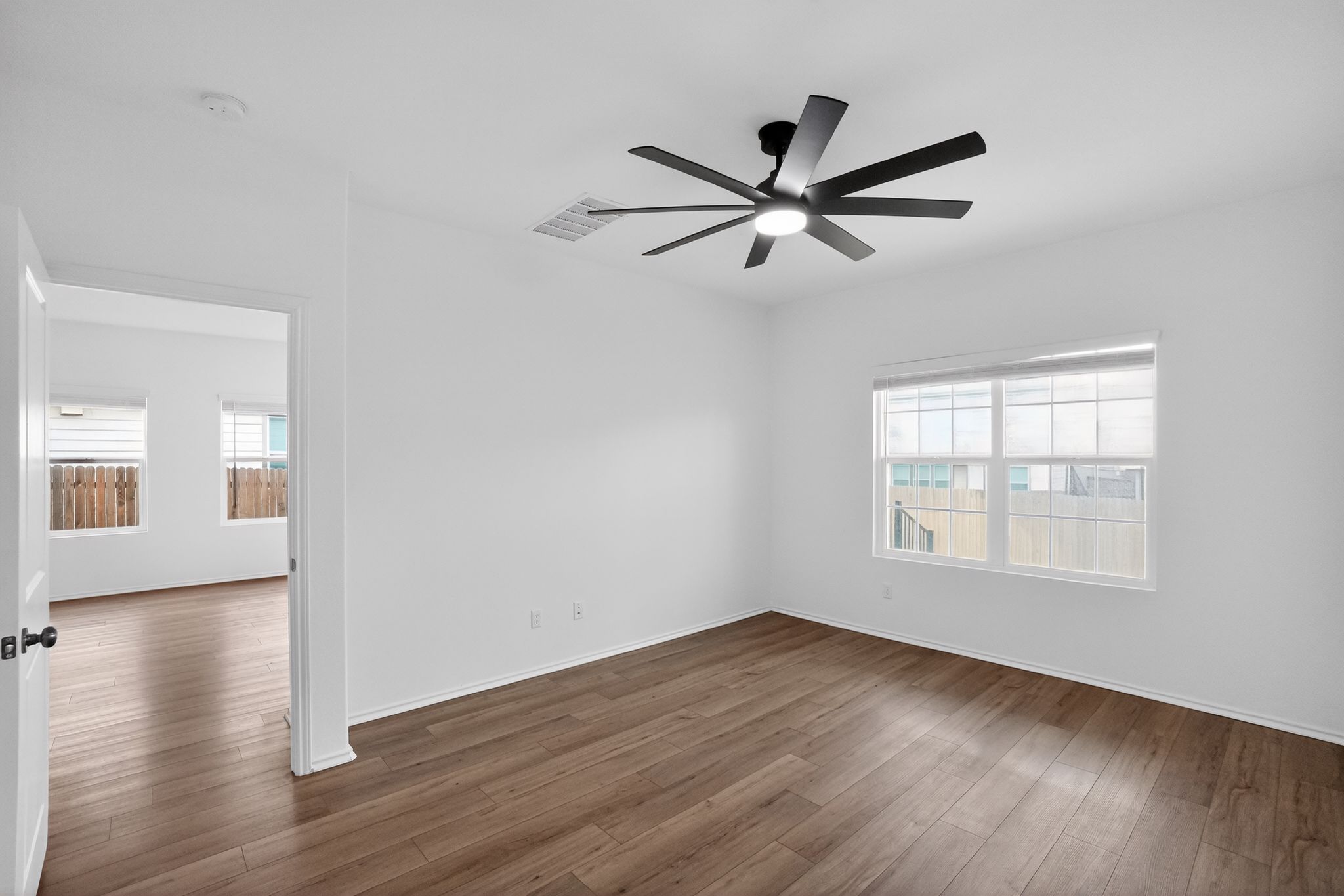 412 Perfect World Loop Jarrell, TX 76537 - Photo 4 of 15 Room featuring wood-finish flooring, a modern black ceiling fan with integrated lighting, and white walls