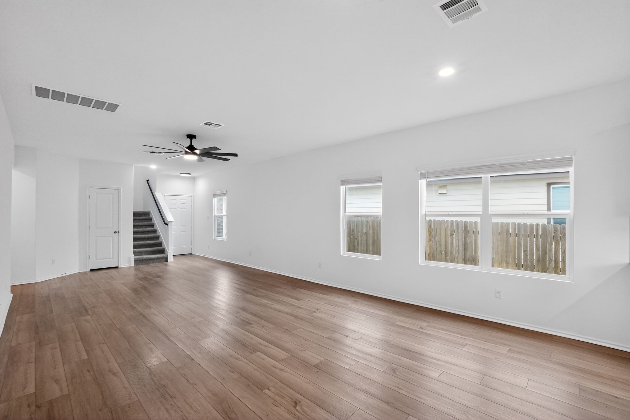 412 Perfect World Loop Jarrell, TX 76537 - Photo 5 of 15 Spacious room featuring wood-finish flooring, white walls, and recessed lighting