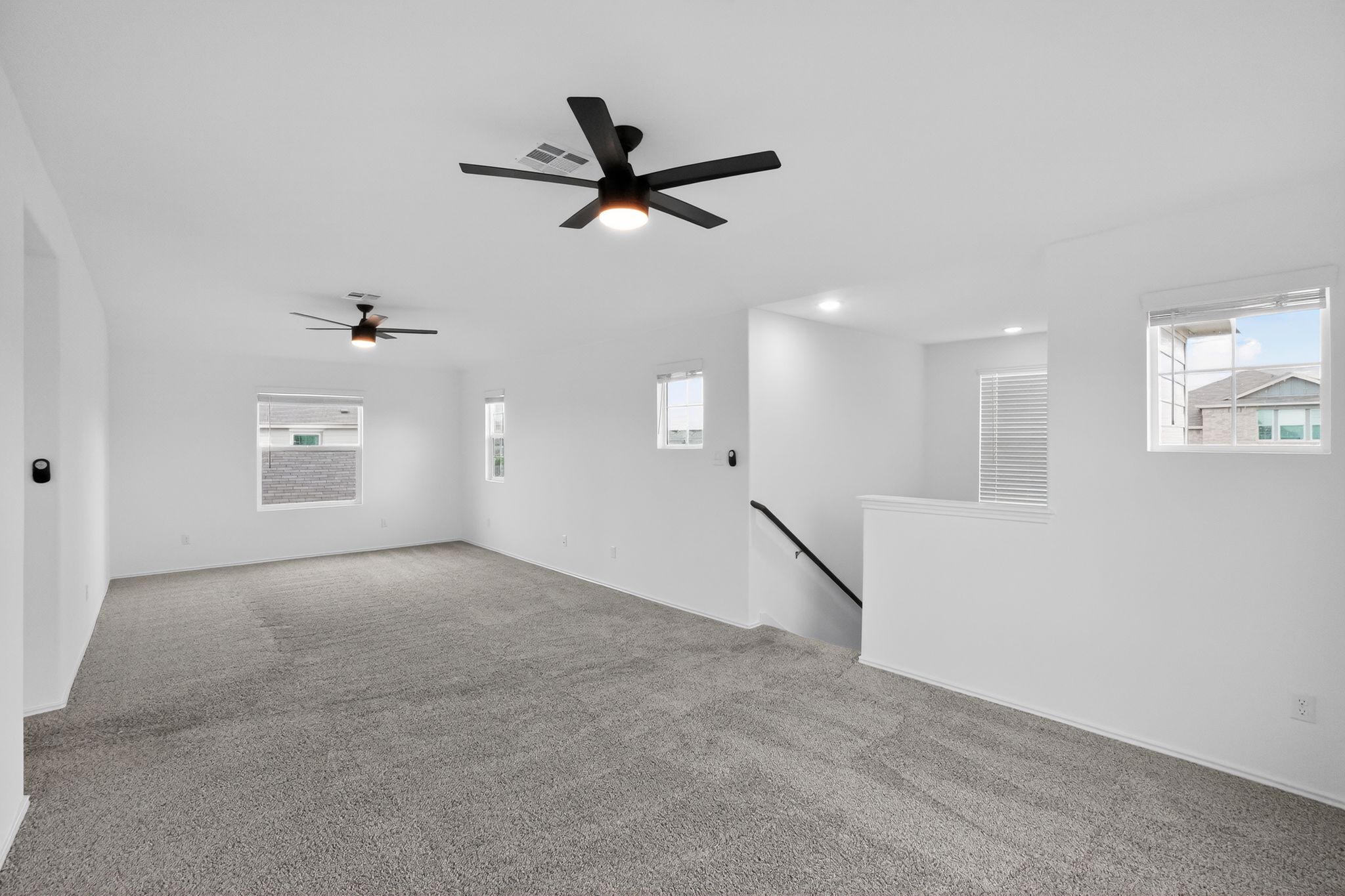 412 Perfect World Loop Jarrell, TX 76537 - Photo 8 of 15 Open concept room featuring plush grey carpeting and crisp white walls