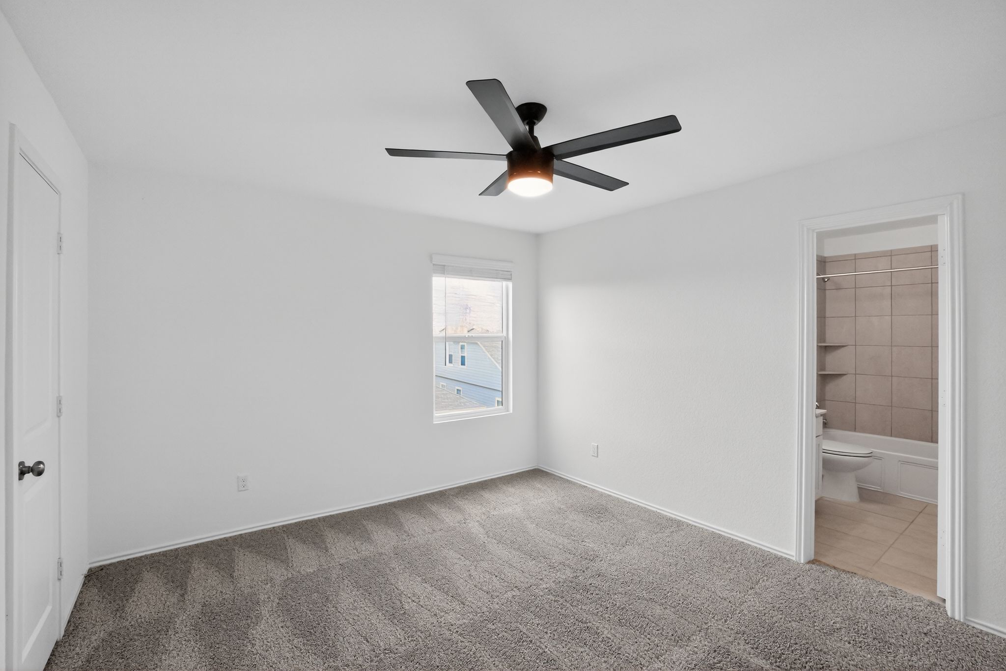 412 Perfect World Loop Jarrell, TX 76537 - Photo 9 of 15 Spacious room featuring neutral carpeting, a ceiling fan with integrated lighting, and a single window with blinds