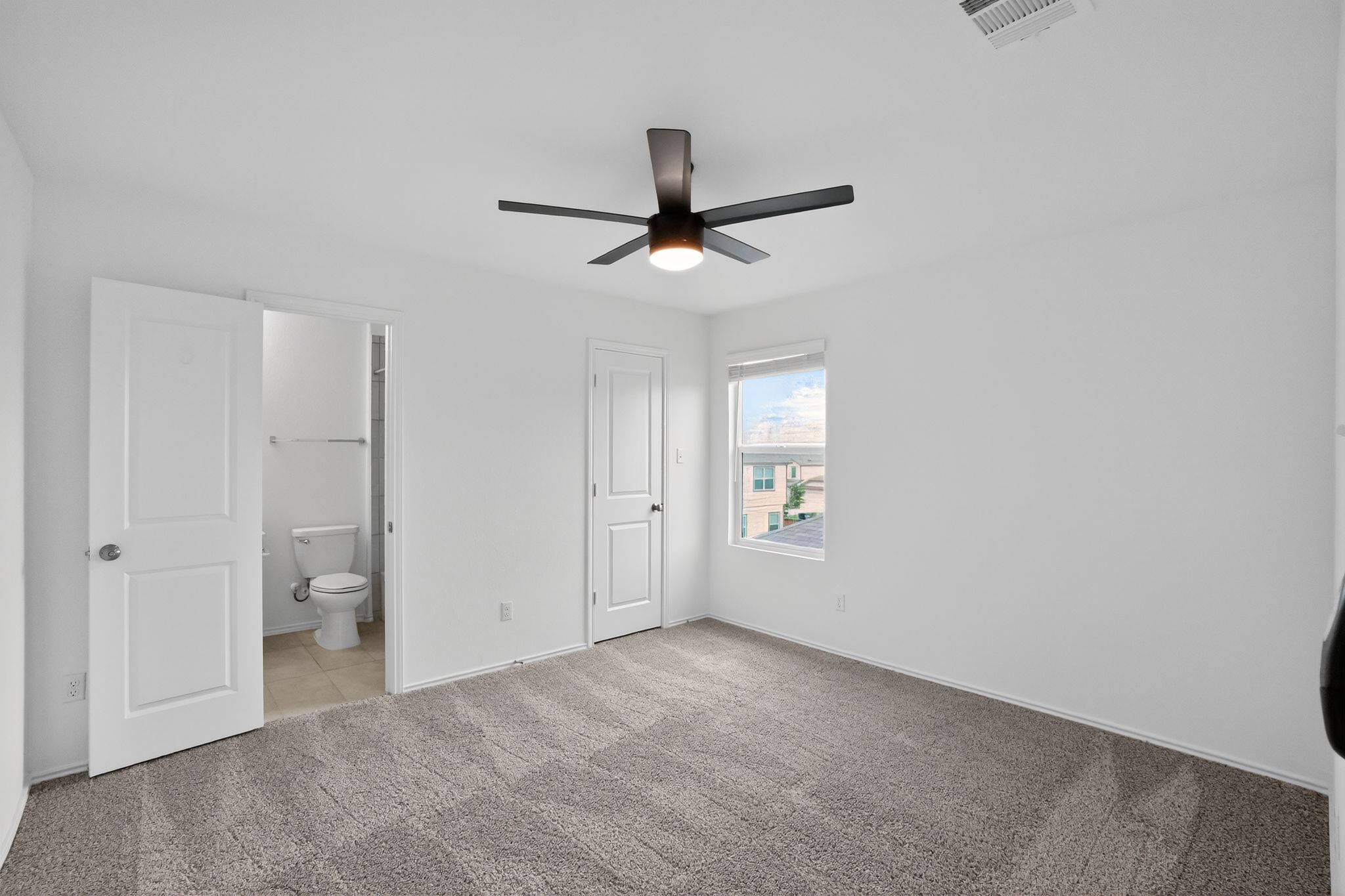 412 Perfect World Loop Jarrell, TX 76537 - Photo 10 of 15 Spacious room featuring neutral carpet flooring, a contemporary ceiling fan with integrated lighting, and a single window providing natural illumination