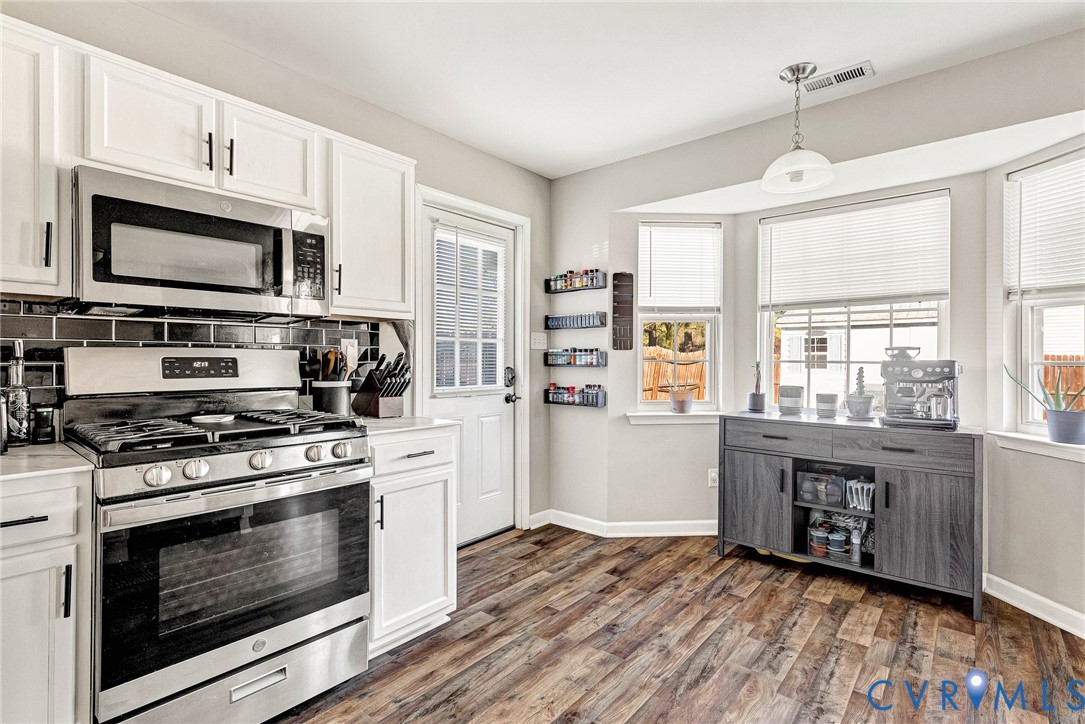 2702 Amherst Ridge Loop Colonial Heights, VA 23834 - Photo 17 of 38 a kitchen with stainless steel appliances granite countertop a stove and a microwave