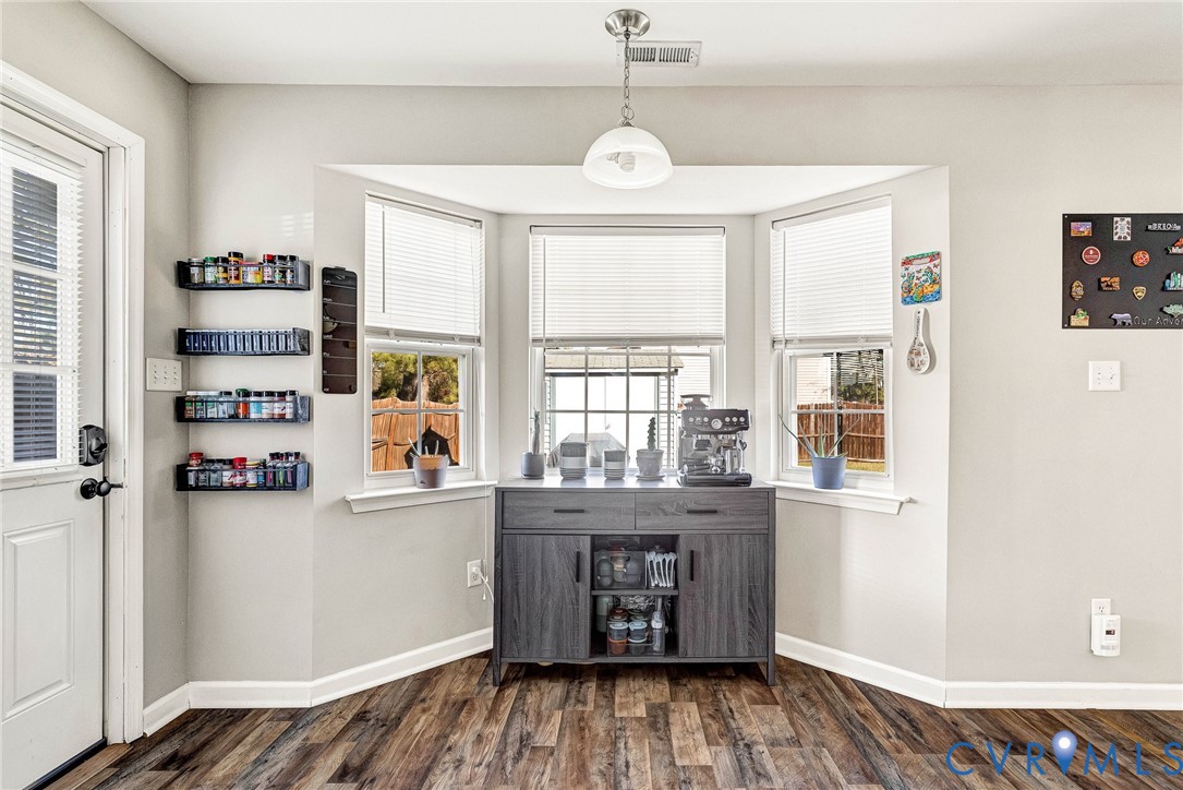 2702 Amherst Ridge Loop Colonial Heights, VA 23834 - Photo 18 of 38 a kitchen with stainless steel appliances granite countertop a refrigerator and wooden floor