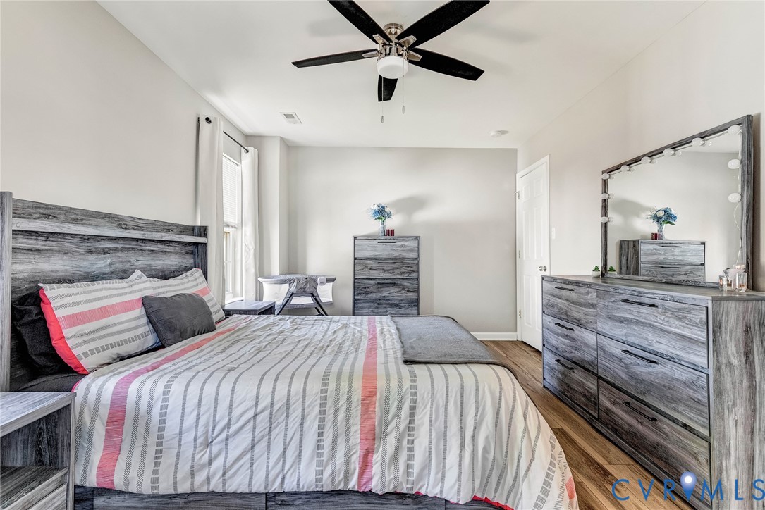 2702 Amherst Ridge Loop Colonial Heights, VA 23834 - Photo 22 of 38 a bedroom with a large bed and a chandelier