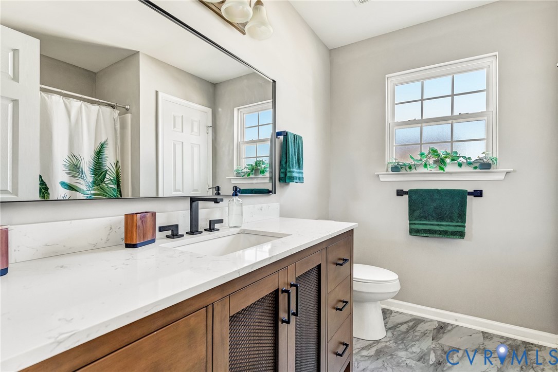 2702 Amherst Ridge Loop Colonial Heights, VA 23834 - Photo 25 of 38 a bathroom with a sink a toilet and mirror