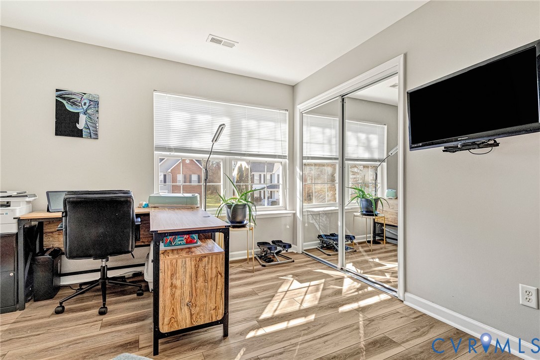 2702 Amherst Ridge Loop Colonial Heights, VA 23834 - Photo 30 of 38 a view of a livingroom with workspace and a flat screen tv