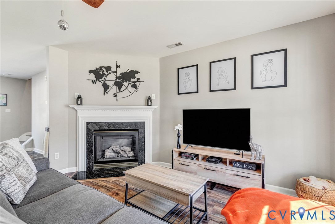 2702 Amherst Ridge Loop Colonial Heights, VA 23834 - Photo 4 of 38 a living room with furniture a flat screen tv and a fireplace