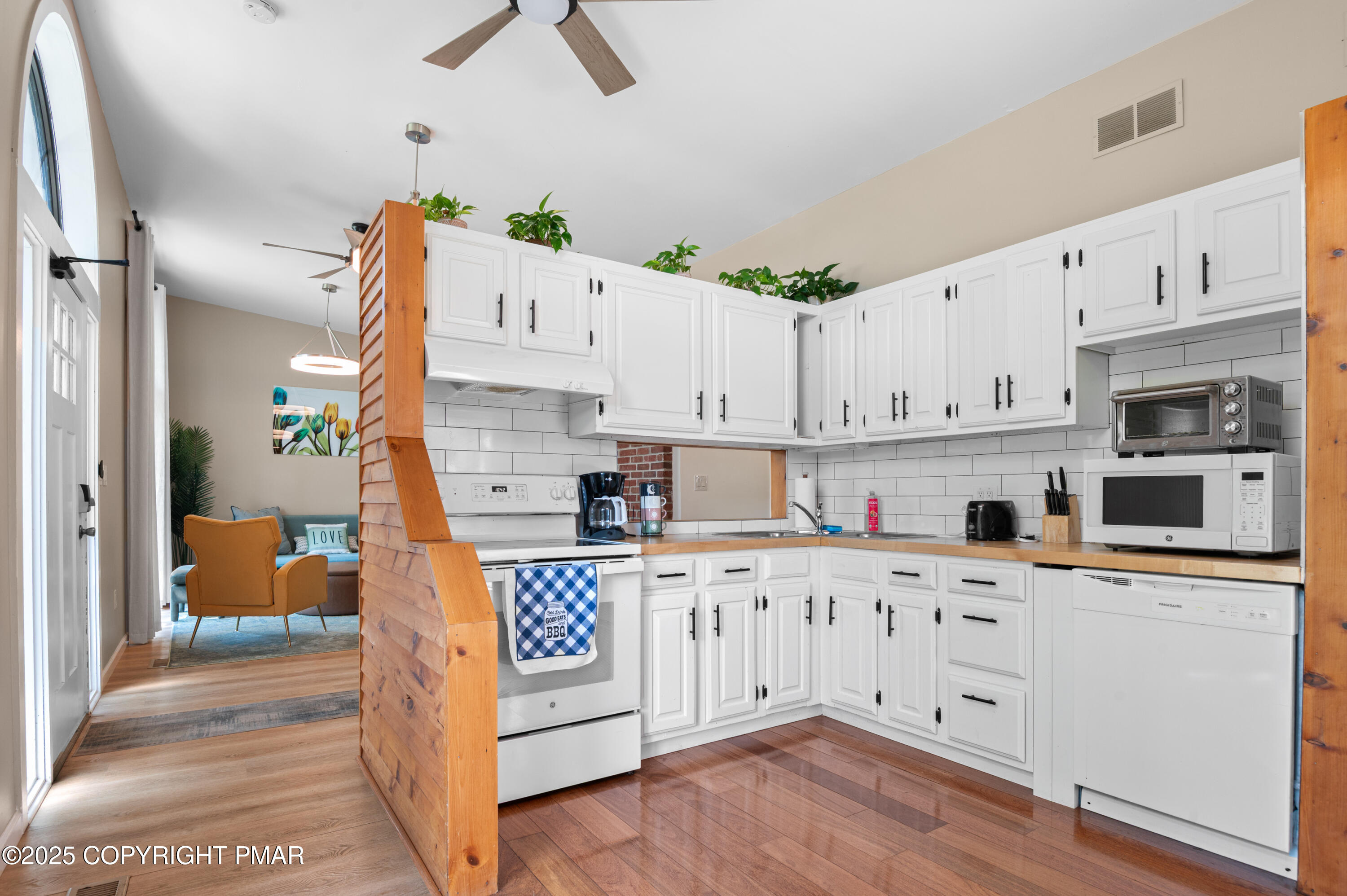 624 Westlake Drive East Stroudsburg, PA 18302 - Photo 106 of 115 a kitchen with stainless steel appliances white cabinets and wooden floors