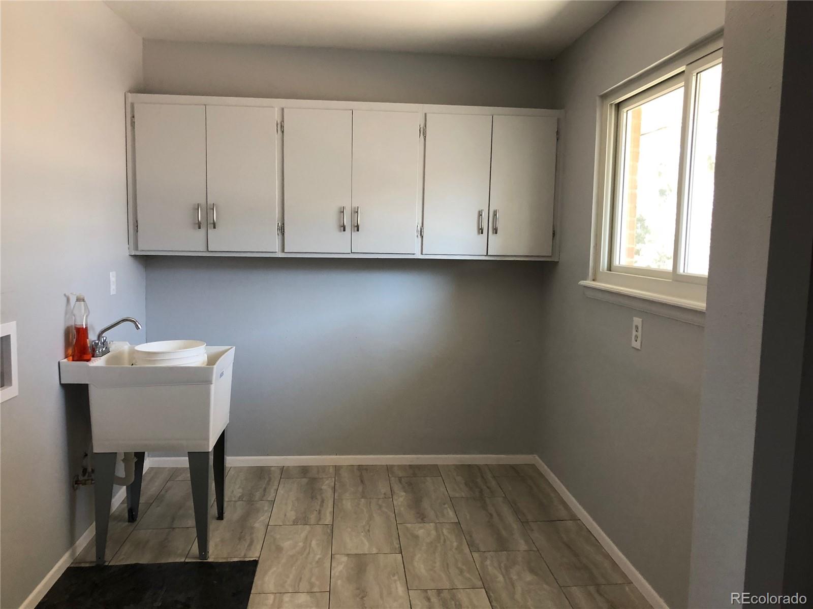 39592 County Road 18 Roggen, CO 80652 - Photo 11 of 34 a view of a room with wooden floor and cabinet