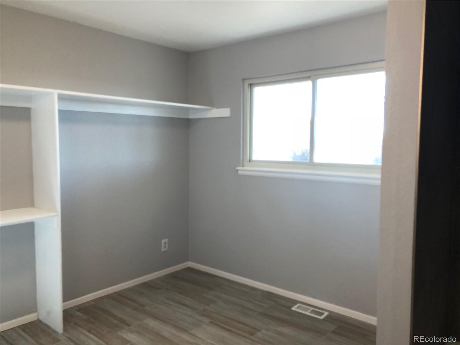 39592 County Road 18 Roggen, CO 80652 - Photo 17 of 34 a view of a small space with wooden floor and a window