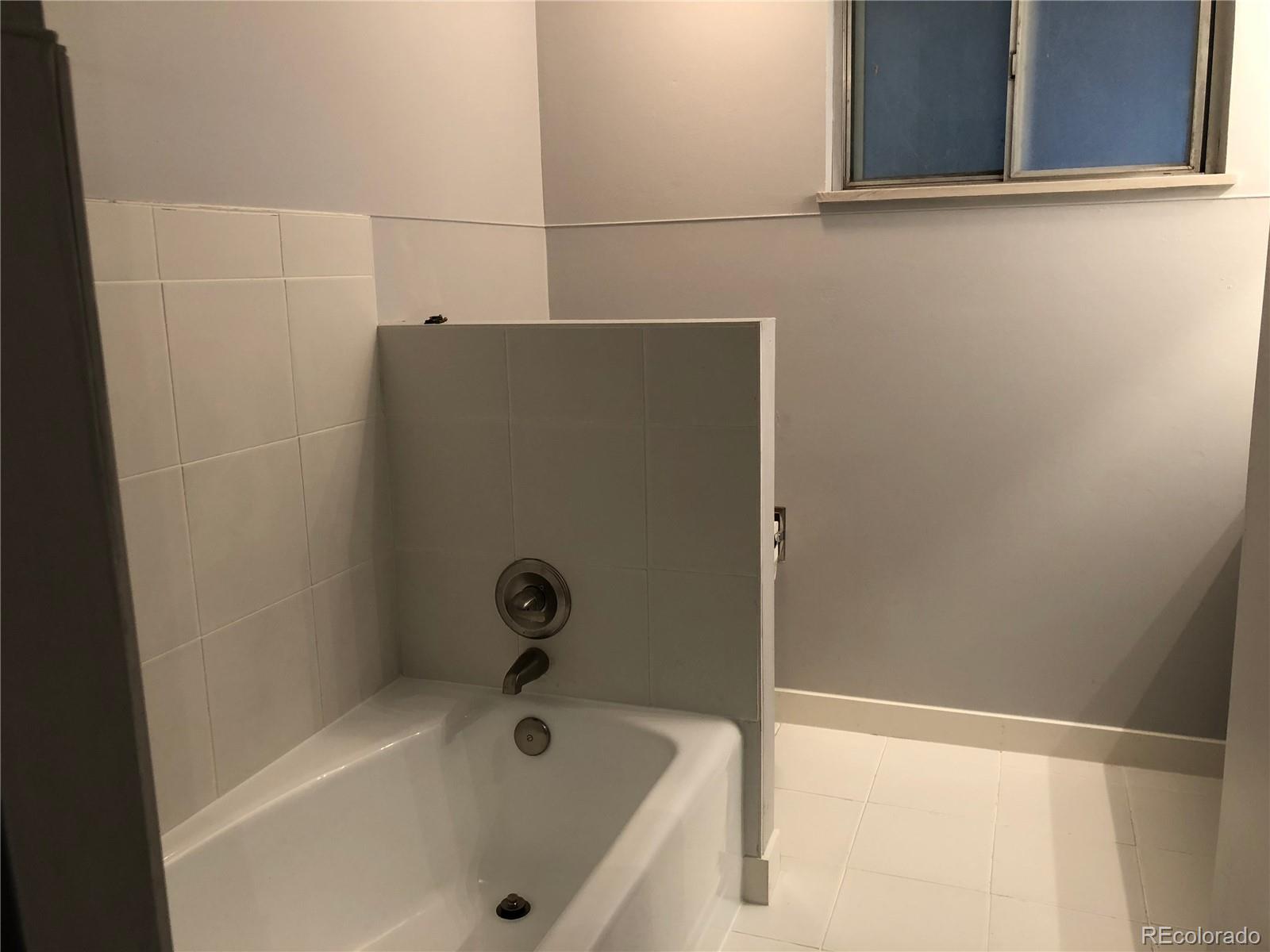 39592 County Road 18 Roggen, CO 80652 - Photo 20 of 34 a bathroom with a tub