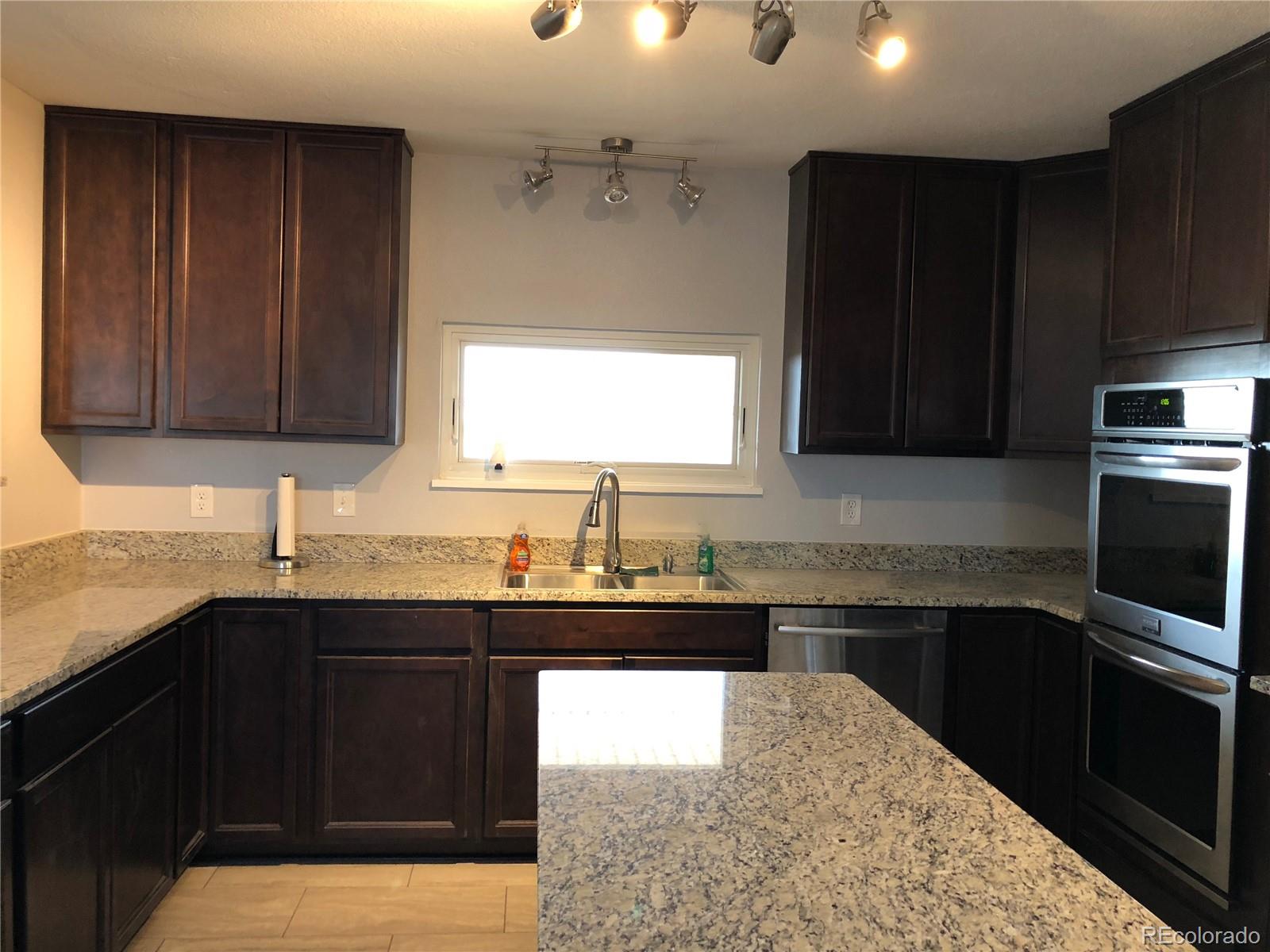 39592 County Road 18 Roggen, CO 80652 - Photo 6 of 34 a kitchen with a sink and a stove