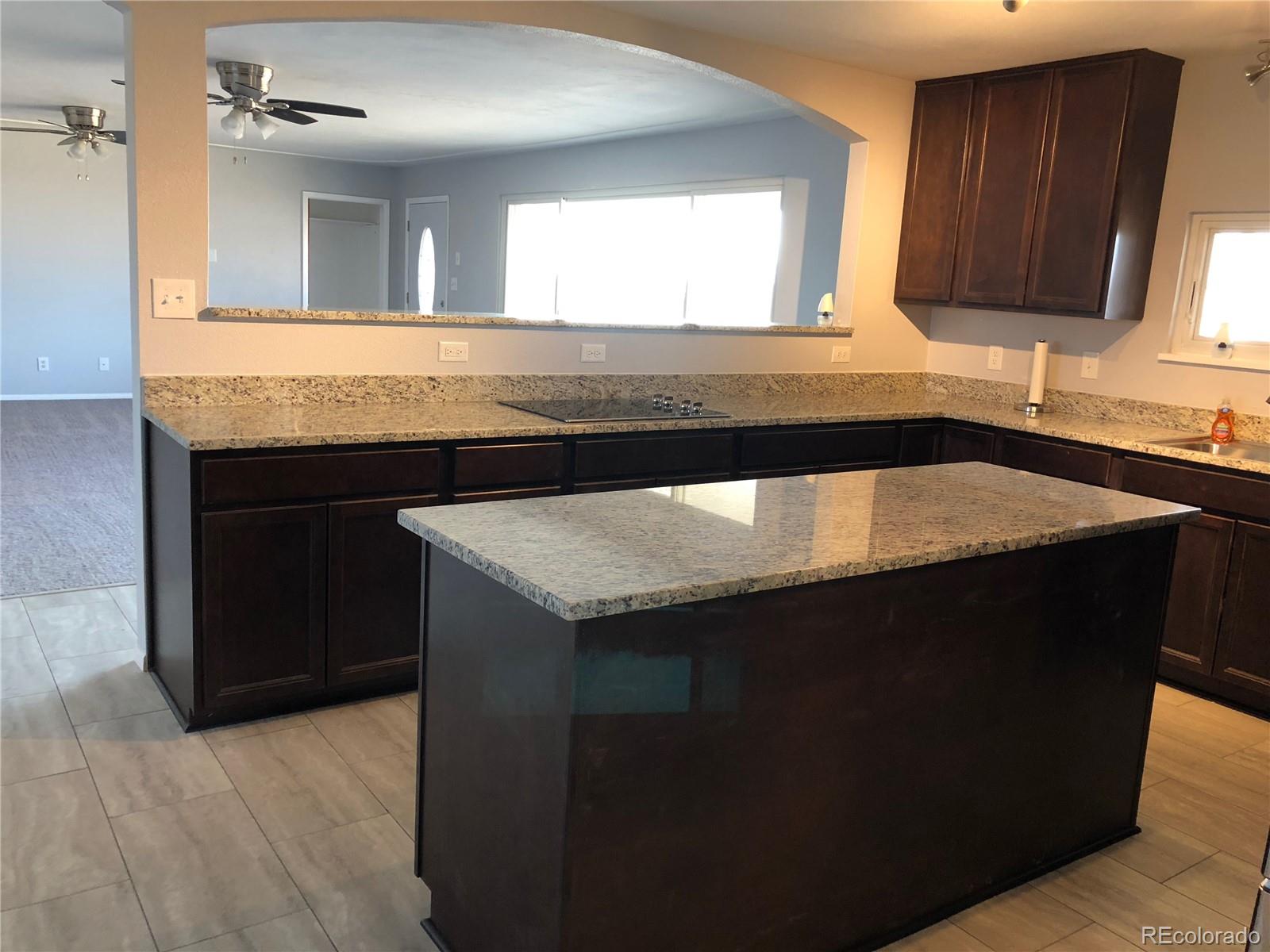 39592 County Road 18 Roggen, CO 80652 - Photo 7 of 34 a kitchen with a sink and a wooden cabinets