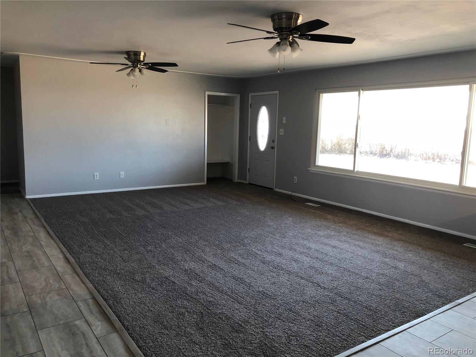39592 County Road 18 Roggen, CO 80652 - Photo 8 of 34 an empty room with windows and fan
