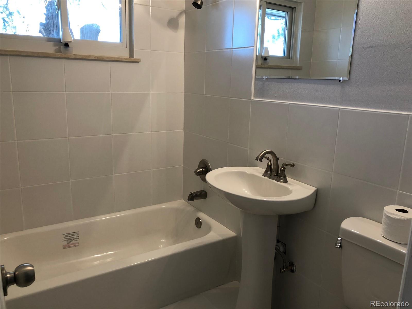 39592 County Road 18 Roggen, CO 80652 - Photo 10 of 34 a bathroom with a sink and a bathtub