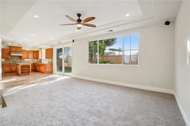 a open kitchen with granite countertop a refrigerator and a sink