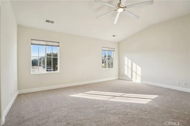 a spacious bathroom with a granite countertop toilet a sink and a bathtub