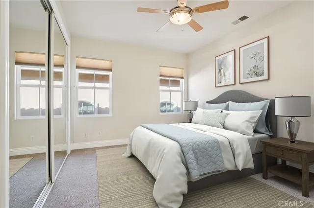 a bedroom with a large bed and a chandelier