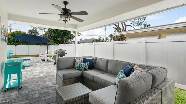 a view of a livingroom with furniture and a floor to ceiling window
