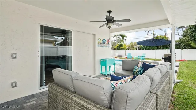 a living room with furniture and a ceiling fan
