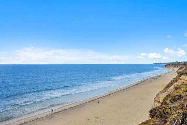 a kitchen with granite countertop white cabinets and a sink