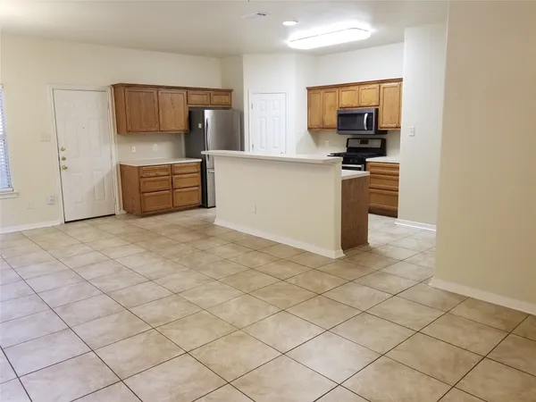 a kitchen with granite countertop a sink and cabinets