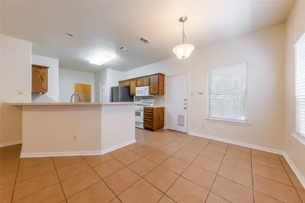 a view of a kitchen with microwave and cabinets
