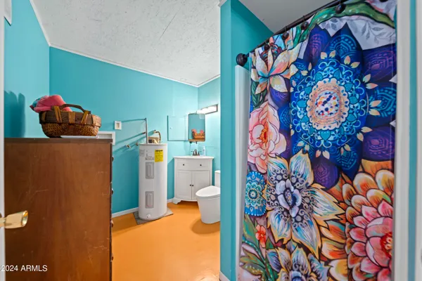 a bedroom with a refrigerator and a painting on the wall