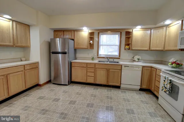 a kitchen with a sink appliances and cabinets