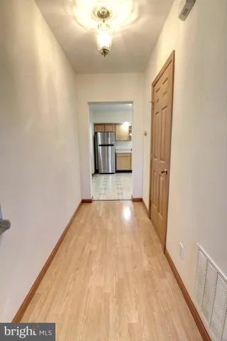 a view of a room with wooden floor and a large window