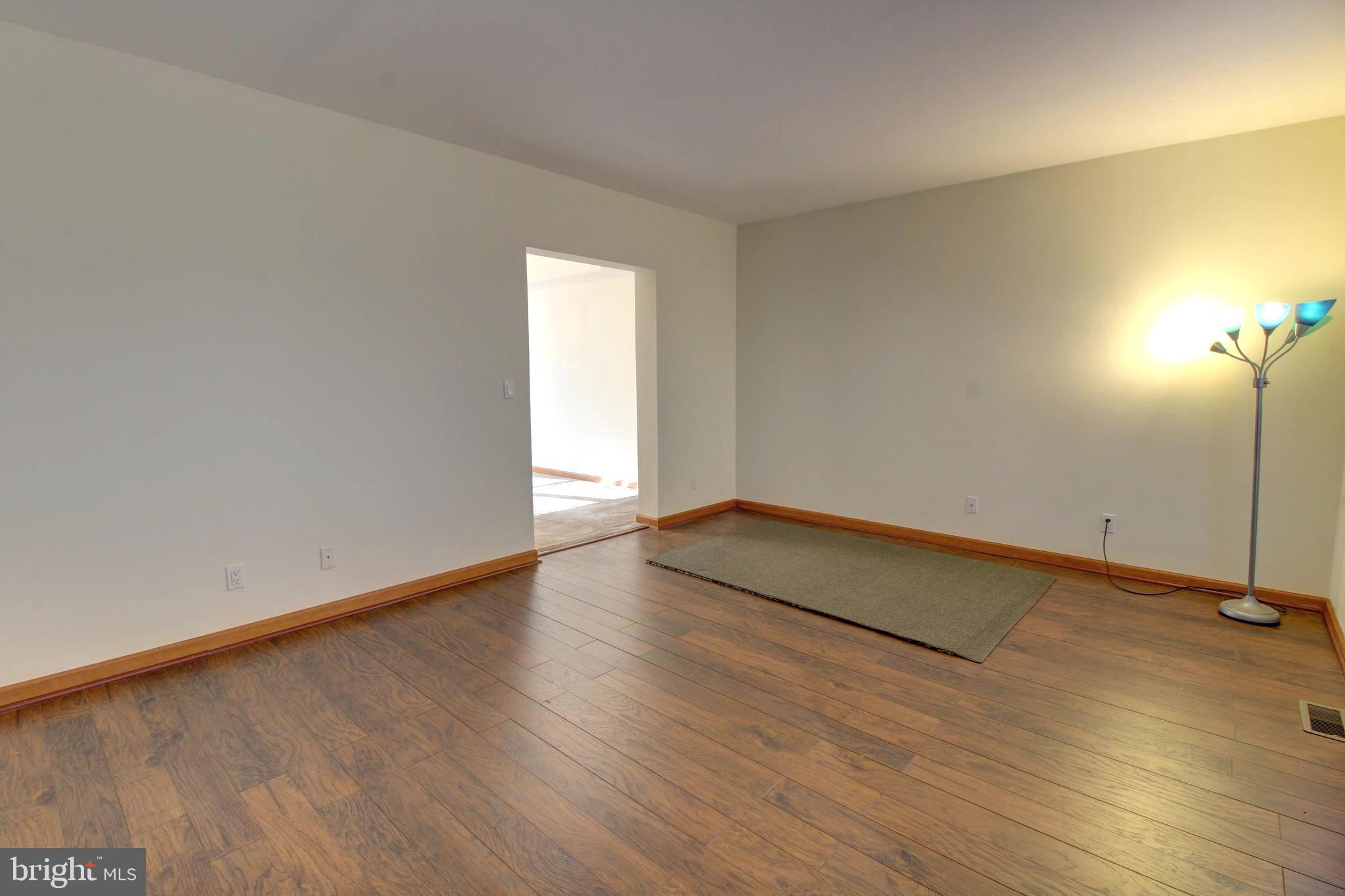 745 Fire Trail Road Front Royal, VA 22630 - Photo 16 of 58 an empty room with wooden floor and windows