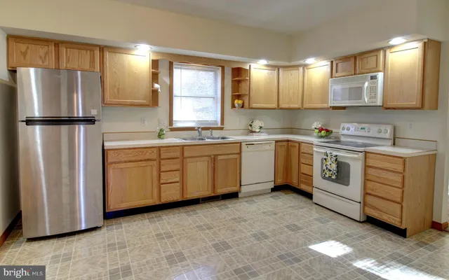 a kitchen with a sink stove and refrigerator
