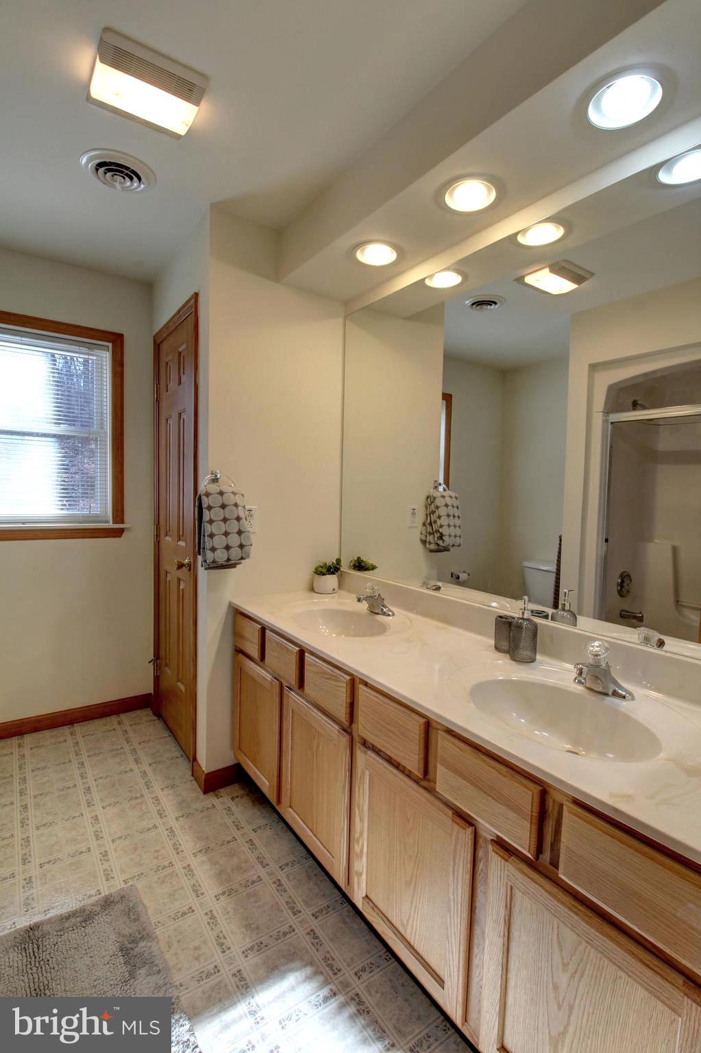745 Fire Trail Road Front Royal, VA 22630 - Photo 40 of 58 a bathroom with a sink double vanity and a mirror