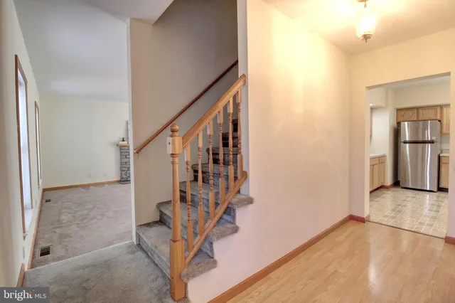 a view of entryway with wooden floor and stairs