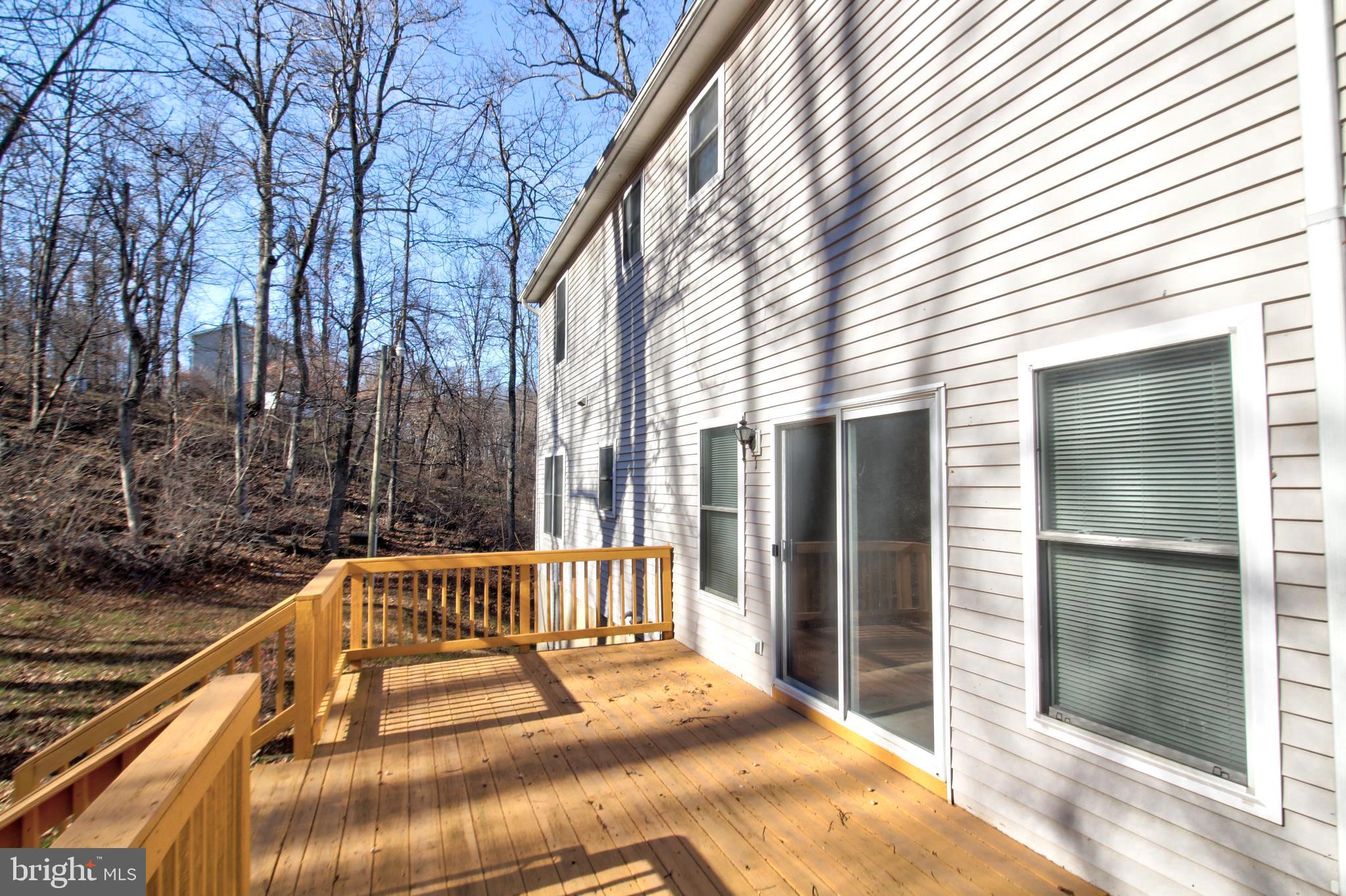 745 Fire Trail Road Front Royal, VA 22630 - Photo 52 of 58 a view of backyard with large trees and wooden fence