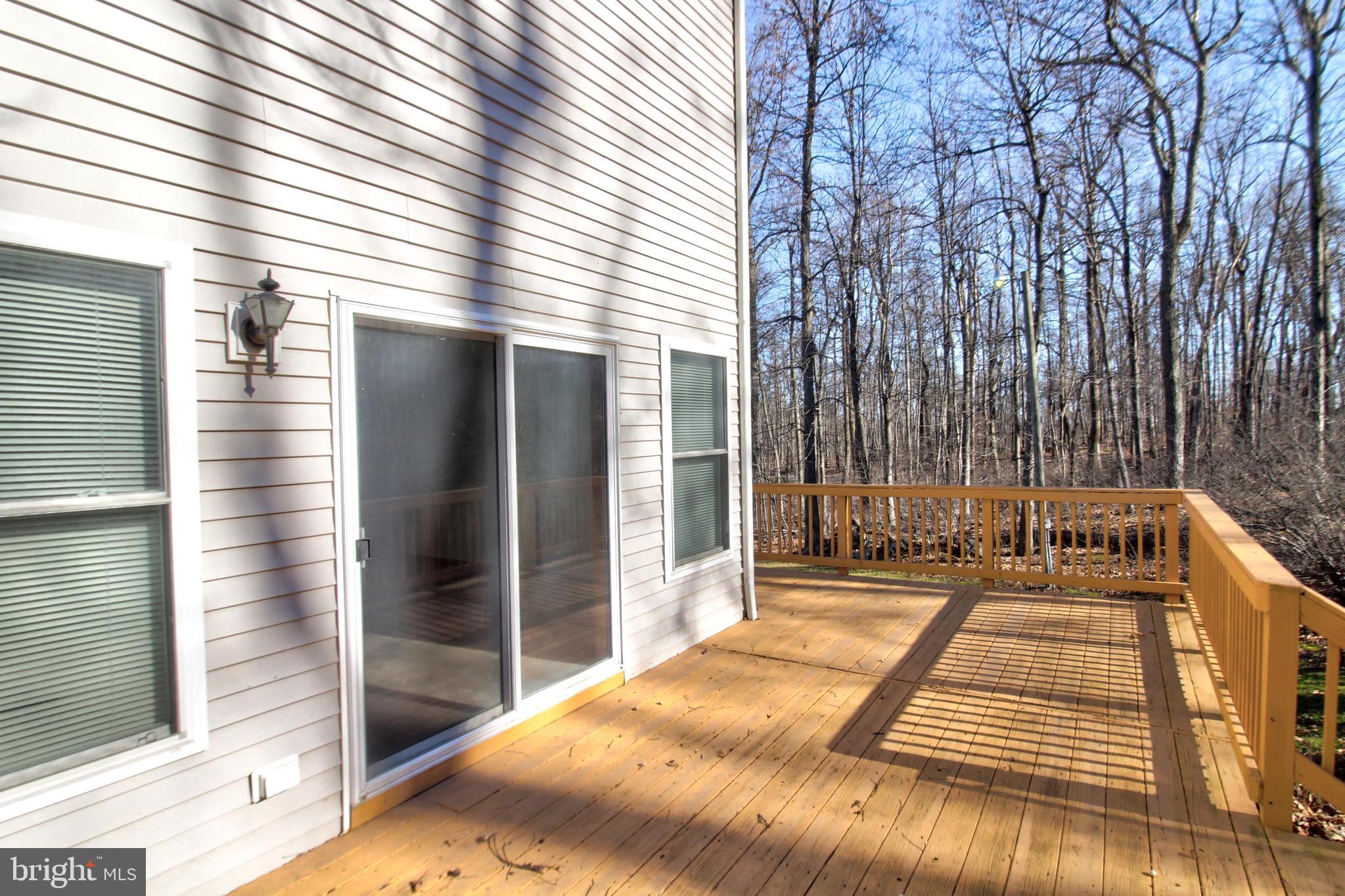 745 Fire Trail Road Front Royal, VA 22630 - Photo 53 of 58 a view of a balcony with wooden floor and fence