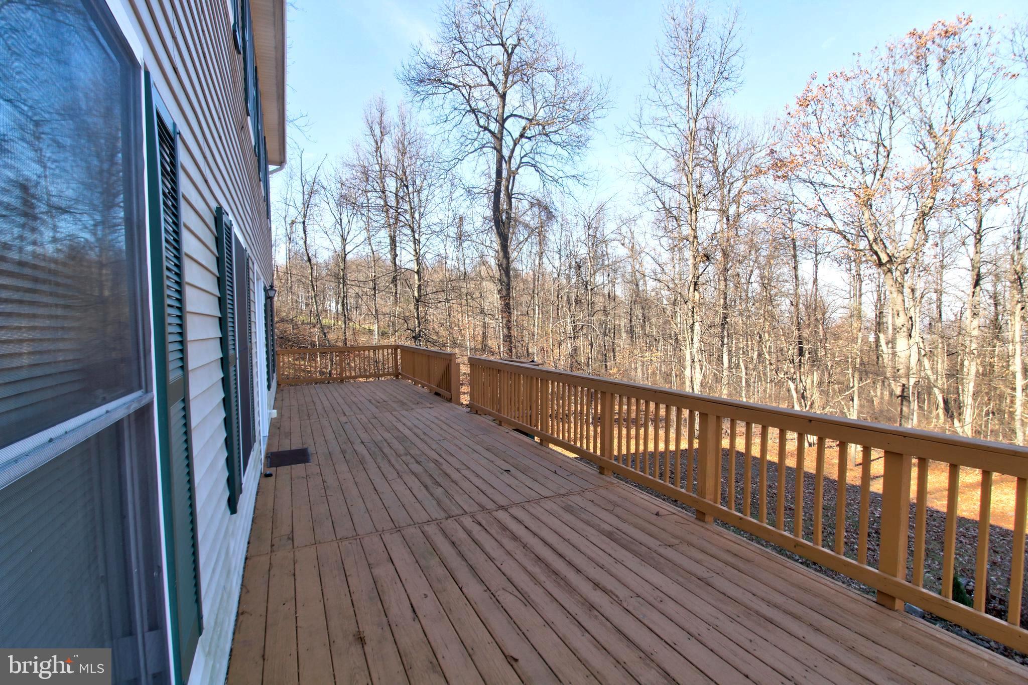 745 Fire Trail Road Front Royal, VA 22630 - Photo 55 of 58 a view of a balcony with wooden floor and fence