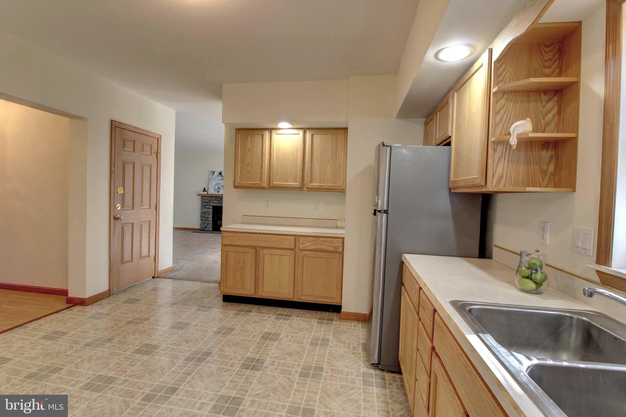 745 Fire Trail Road Front Royal, VA 22630 - Photo 9 of 58 a kitchen that has a sink a refrigerator and cabinets