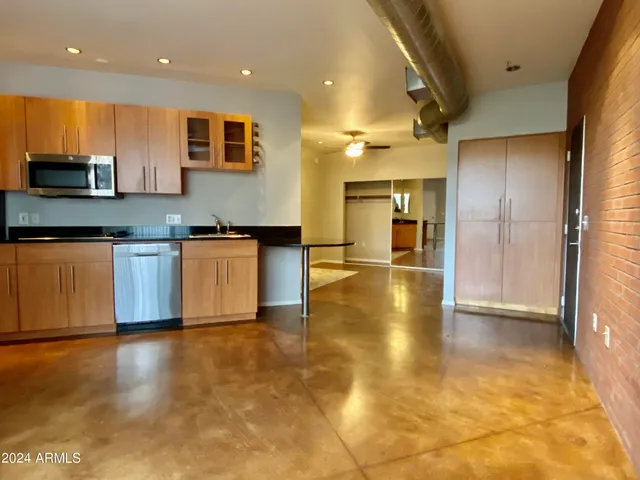 a view of a kitchen with a sink and a window