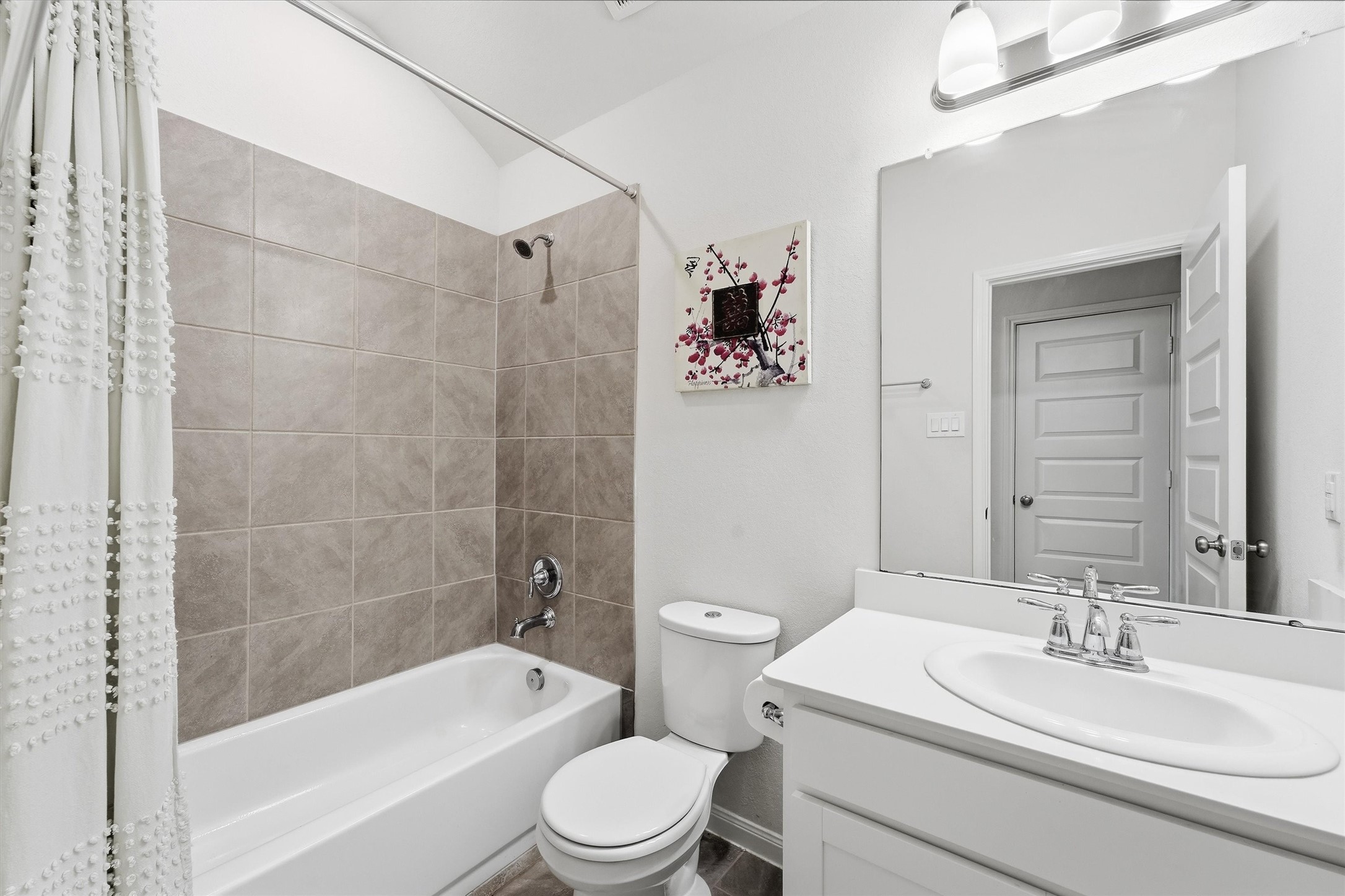 1007 Modesto Drive Rosharon, TX 77583 - Photo 19 of 25 Full secondary bathroom featuring a tub and shower combination with tile surround and a bright vanity area.