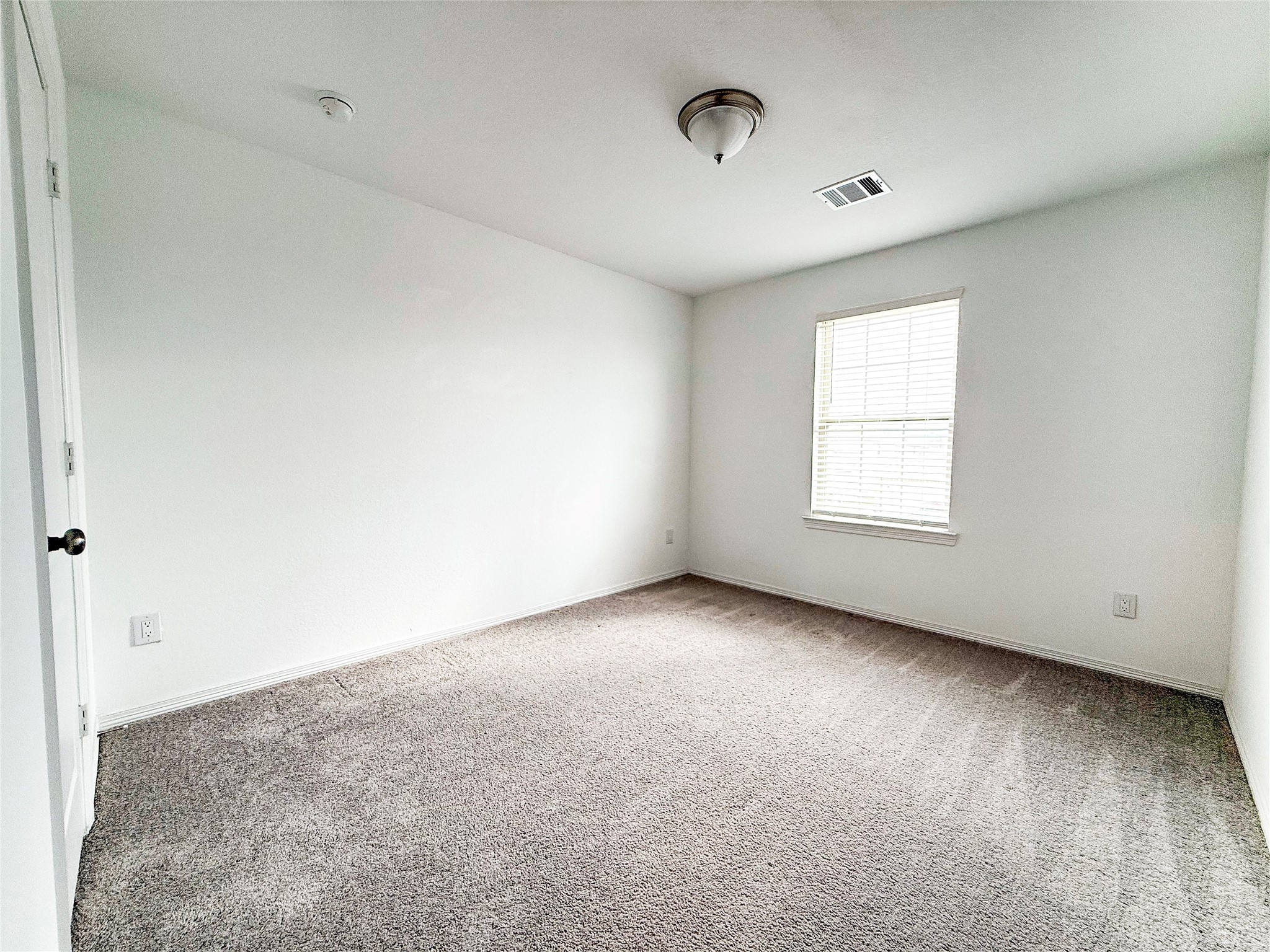 19623 Cat Spruce Court Porter, TX 77365 - Photo 11 of 25 an empty room with a window and a projector screen