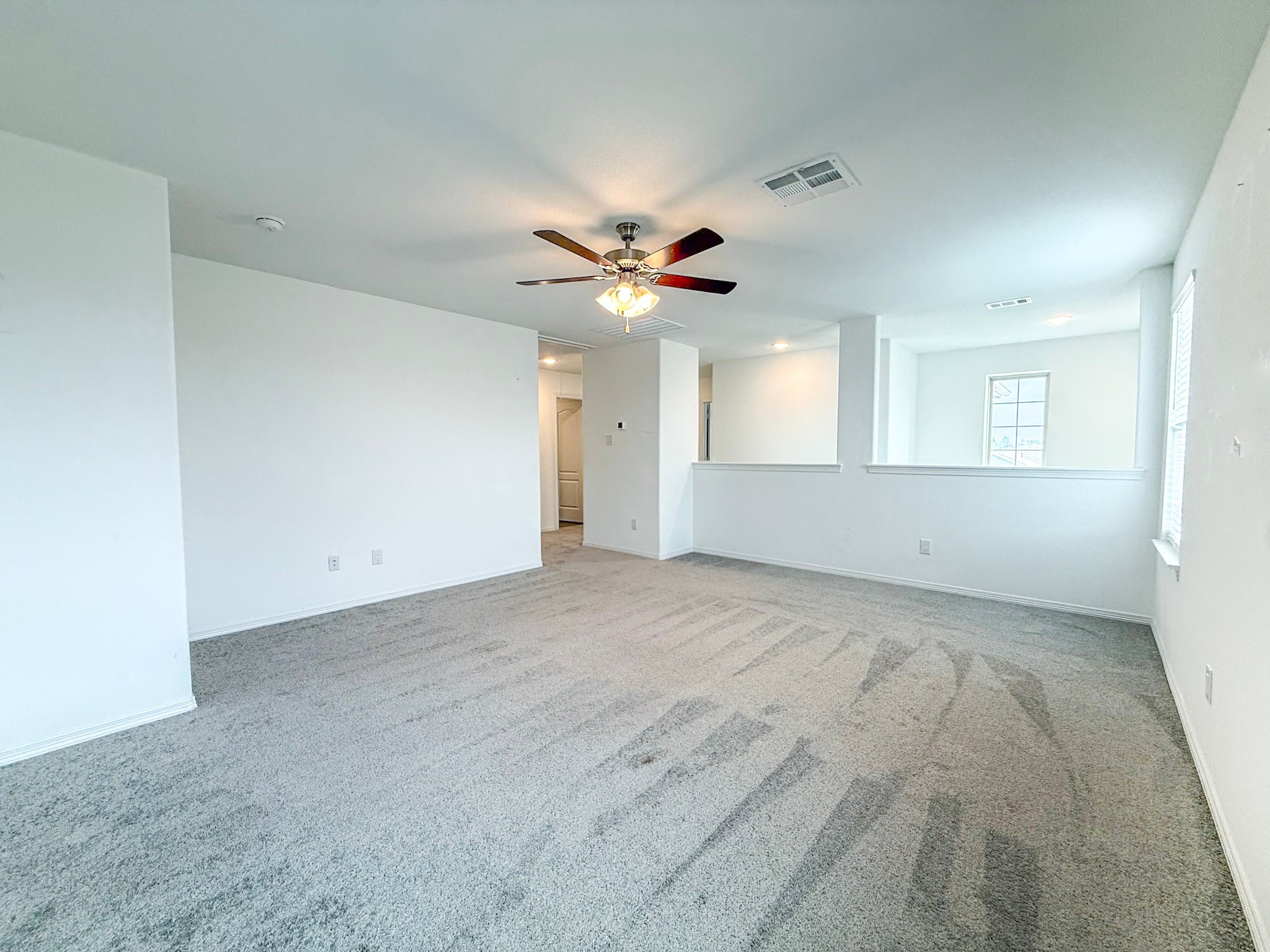 19623 Cat Spruce Court Porter, TX 77365 - Photo 16 of 25 an empty room with ceiling fan and window