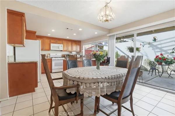 a view of a dining room with furniture and a chandelier