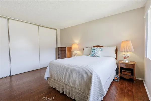 a bedroom with a bed and wooden floor