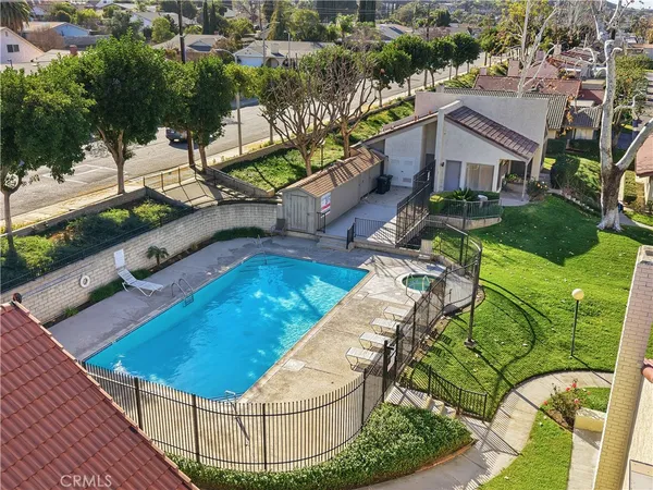 an aerial view of a house with a yard and lake view