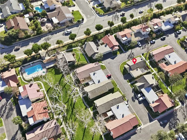 an aerial view of residential houses with outdoor space