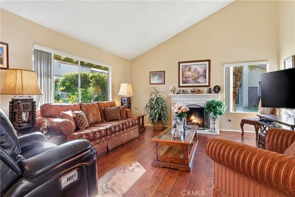 a living room with furniture flat screen tv and a large window