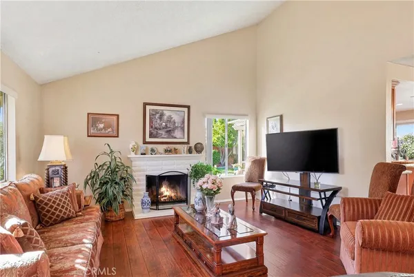 a living room with furniture a flat screen tv and a fireplace