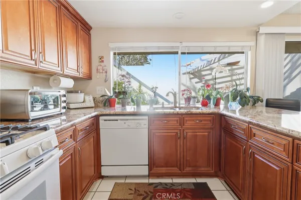 a kitchen with stainless steel appliances a sink stove and cabinets